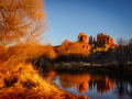 Firey December glow frames Cathedral rock and its reflection